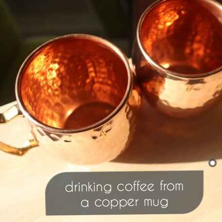 drinking coffee from a copper mug